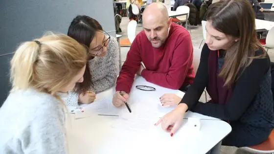 A group of students sitting with an advisor at a LSE LIFE session